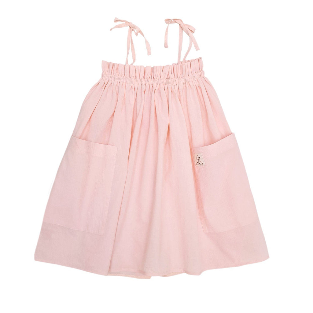 5. Flat lay of peach dress with adjustable shoulder ties and front pockets on white background