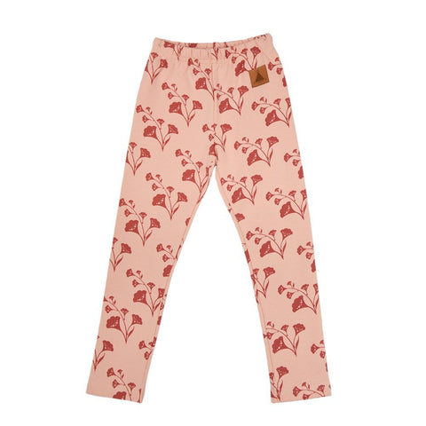 4. Flat lay of kids' pink leggings with red bellflower print and elastic waistband, made from OEKO-TEX cotton and elastane by Zezuzulla