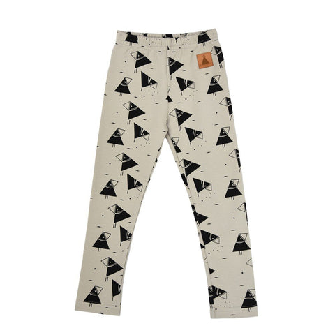 4. Flat lay of kids' beige leggings with black bird print and elastic waistband, featuring Zezuzulla brand patch, made from OEKO-TEX cotton and elastane blend
