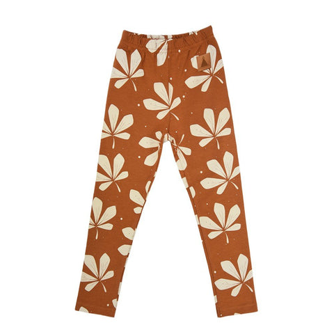 4. Flat lay of kids' chestnut leggings with white leaf pattern, featuring elastic waistband, made from OEKO-TEX cotton and elastane by Zezuzulla