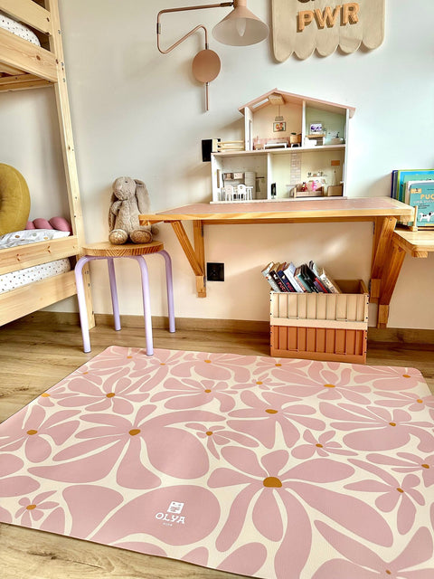 3. Pink daisy-patterned OLYA KIDS floor mat in children's playroom with toys and books