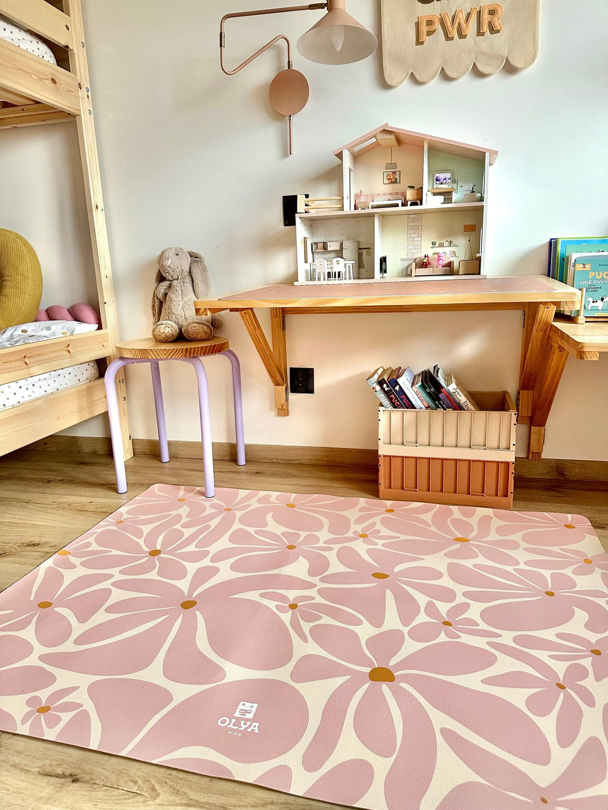 1. Playroom with pink daisy-patterned OLYA KIDS floor mat under play table