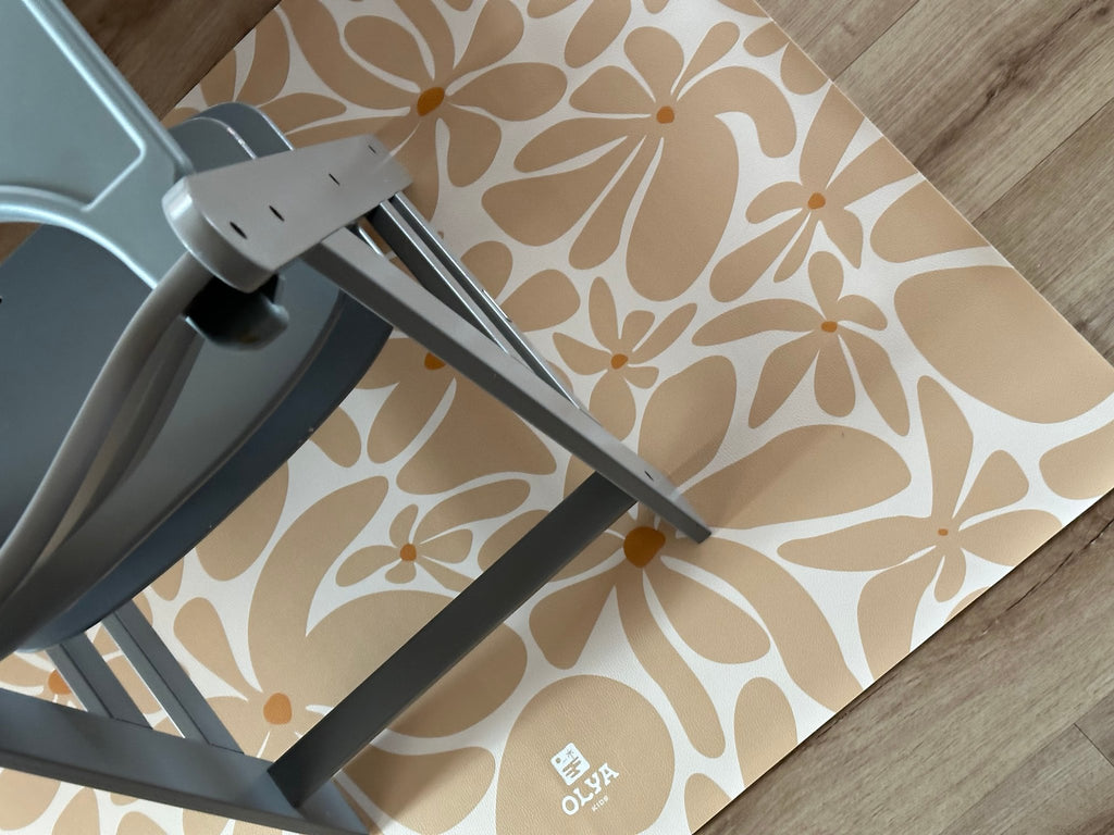 3. Close-up of beige daisy-patterned OLYA KIDS floor mat under grey chair
