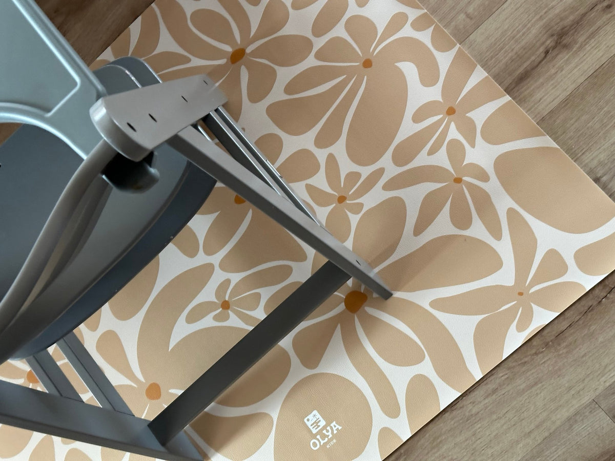 3. Close-up of beige daisy-patterned OLYA KIDS floor mat under grey chair