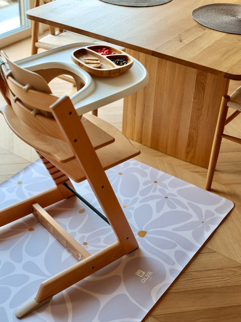 1. Wooden high chair on lavender daisy-patterned floor mat in dining room setting