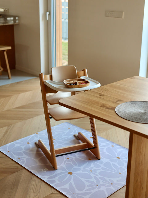 2. Dining room with wooden high chair on lavender daisy-patterned floor mat