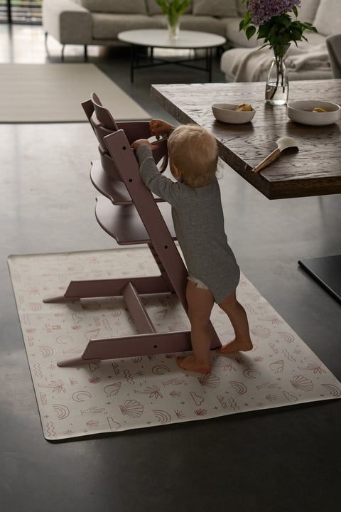2. Child standing by pink high chair on OLYA KIDS palm beach terra floor mat in dining area