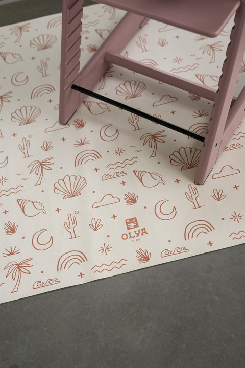 5. Close-up of OLYA KIDS logo on palm beach terra floor mat with pink high chair