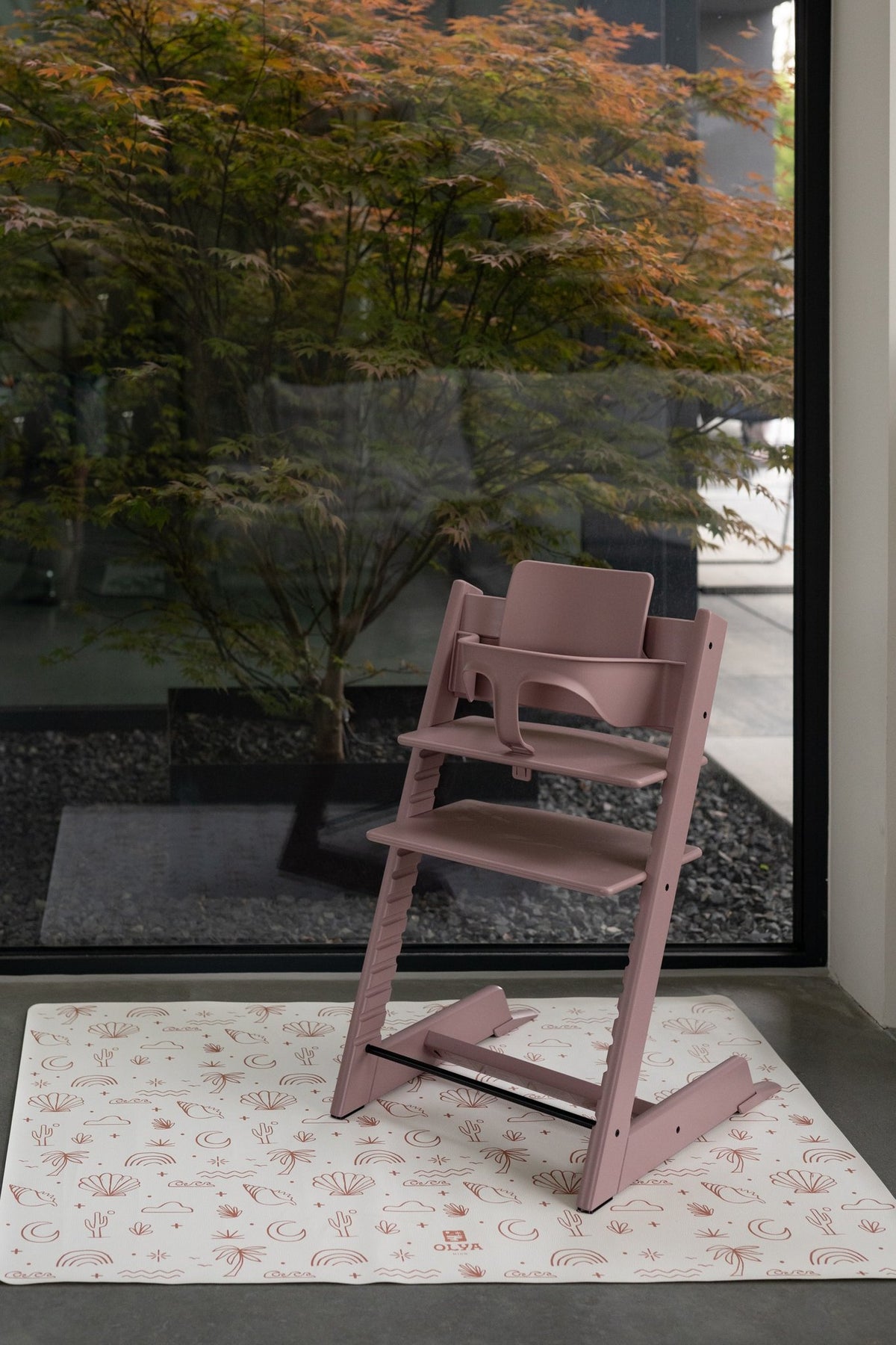 7. Pink high chair on OLYA KIDS palm beach terra floor mat by large window with garden view