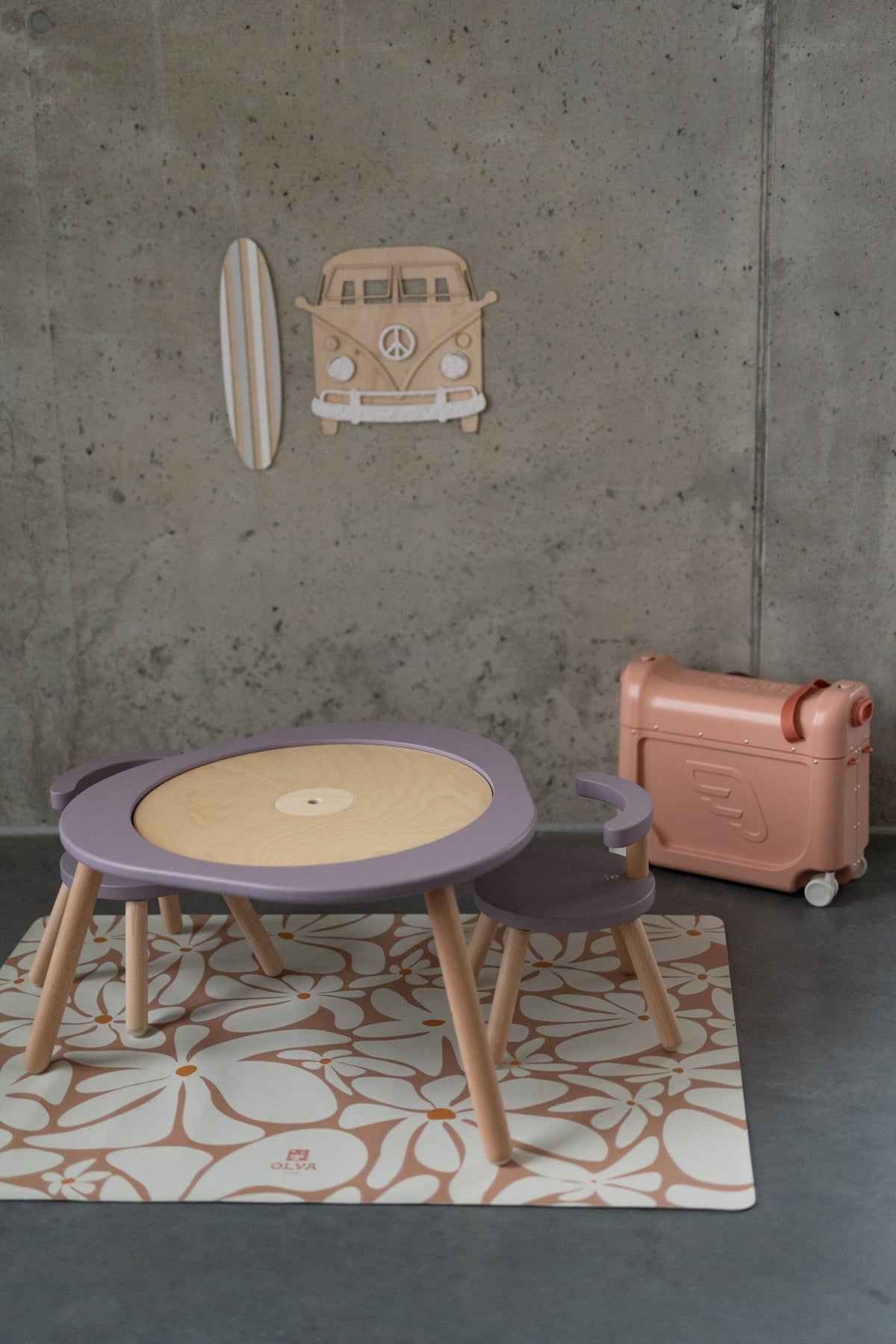 1. Kids' play area with daisy floor mat, purple table and chair, and wall decor