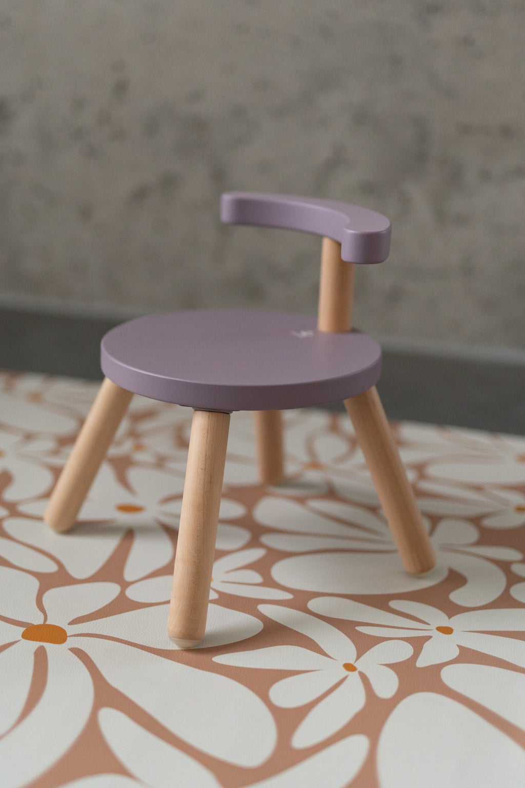 2. Close-up of purple chair on kids' floor mat with daisy pattern