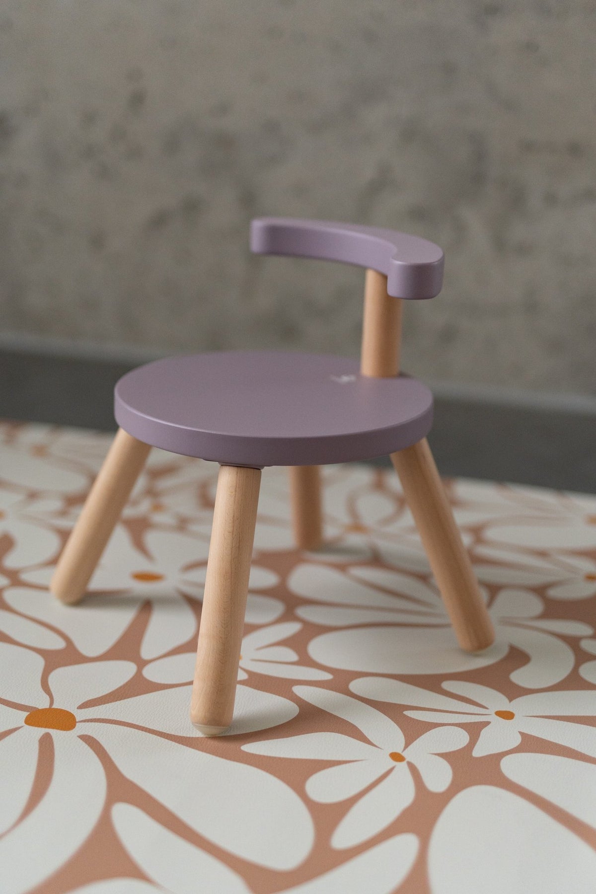 2. Close-up of purple chair on kids' floor mat with daisy pattern