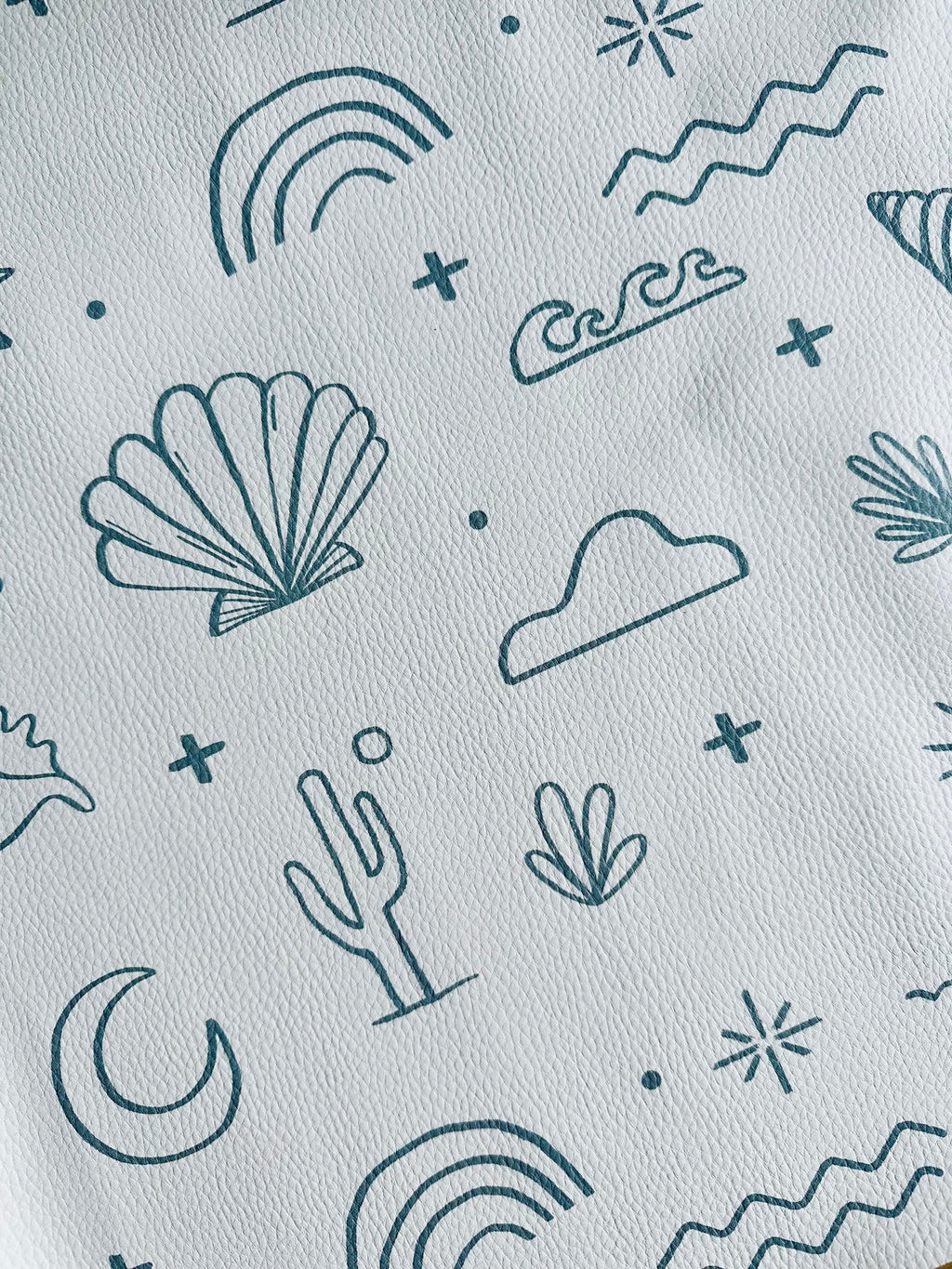 3. Close-up of OLYA KIDS floor mat with palm trees, shells, and waves pattern