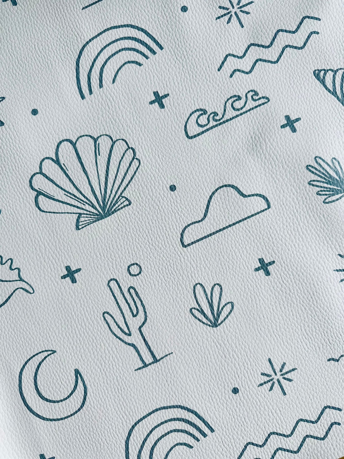 3. Close-up of OLYA KIDS floor mat with palm trees, shells, and waves pattern