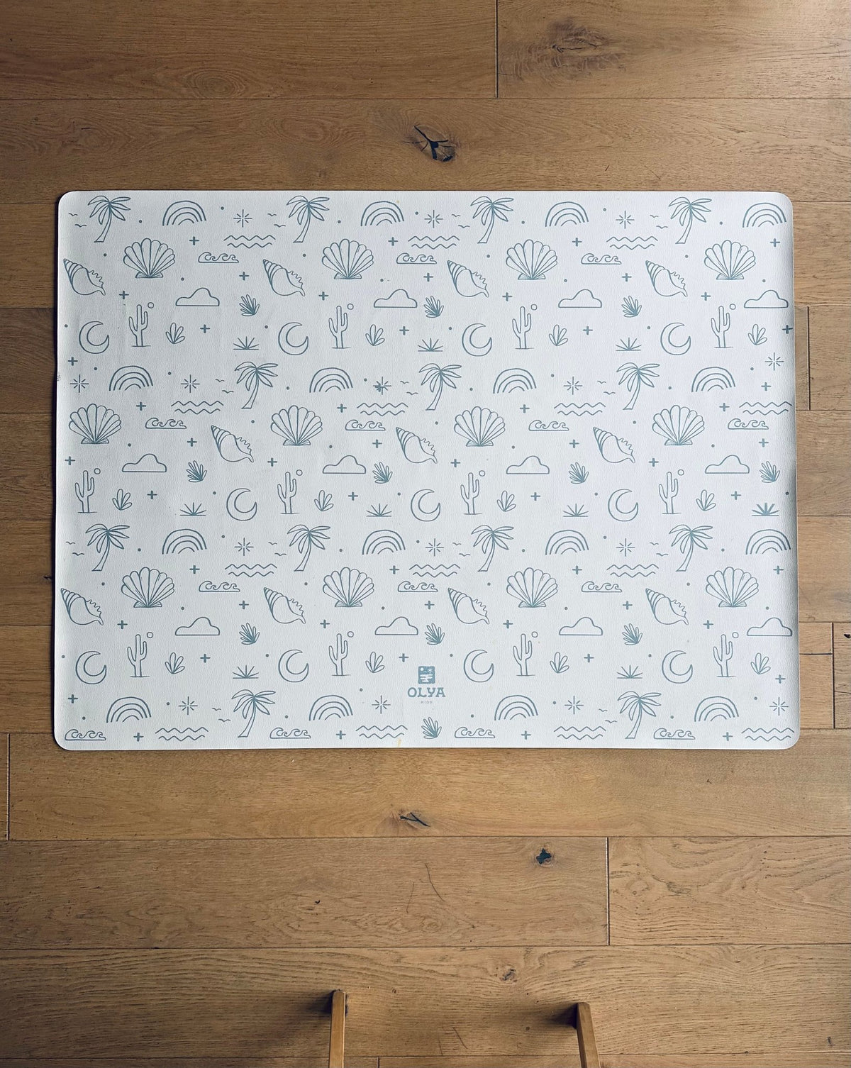2. OLYA KIDS Palm Beach Azure floor mat with playful beach-themed patterns on wooden floor