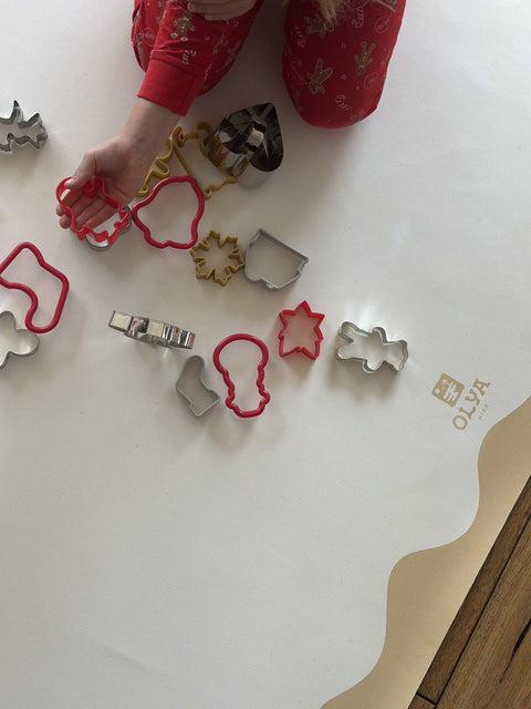 3. Close-up of OLYA KIDS logo on yellow-framed vegan leather floor mat with cookie cutters on top