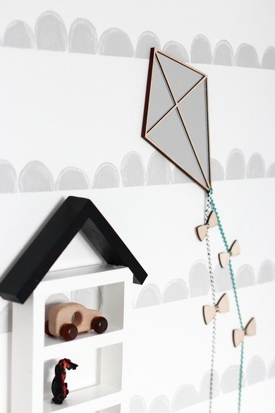 2. Child-friendly kite mirror with acrylic surface and decorative bows on playroom wall