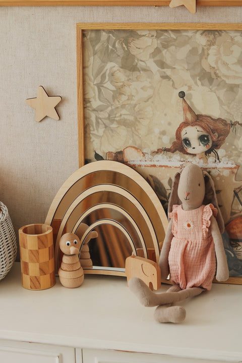 1. Rainbow-shaped mirror with gold-tinted acrylic and natural plywood frame on a nursery shelf with toys and decor