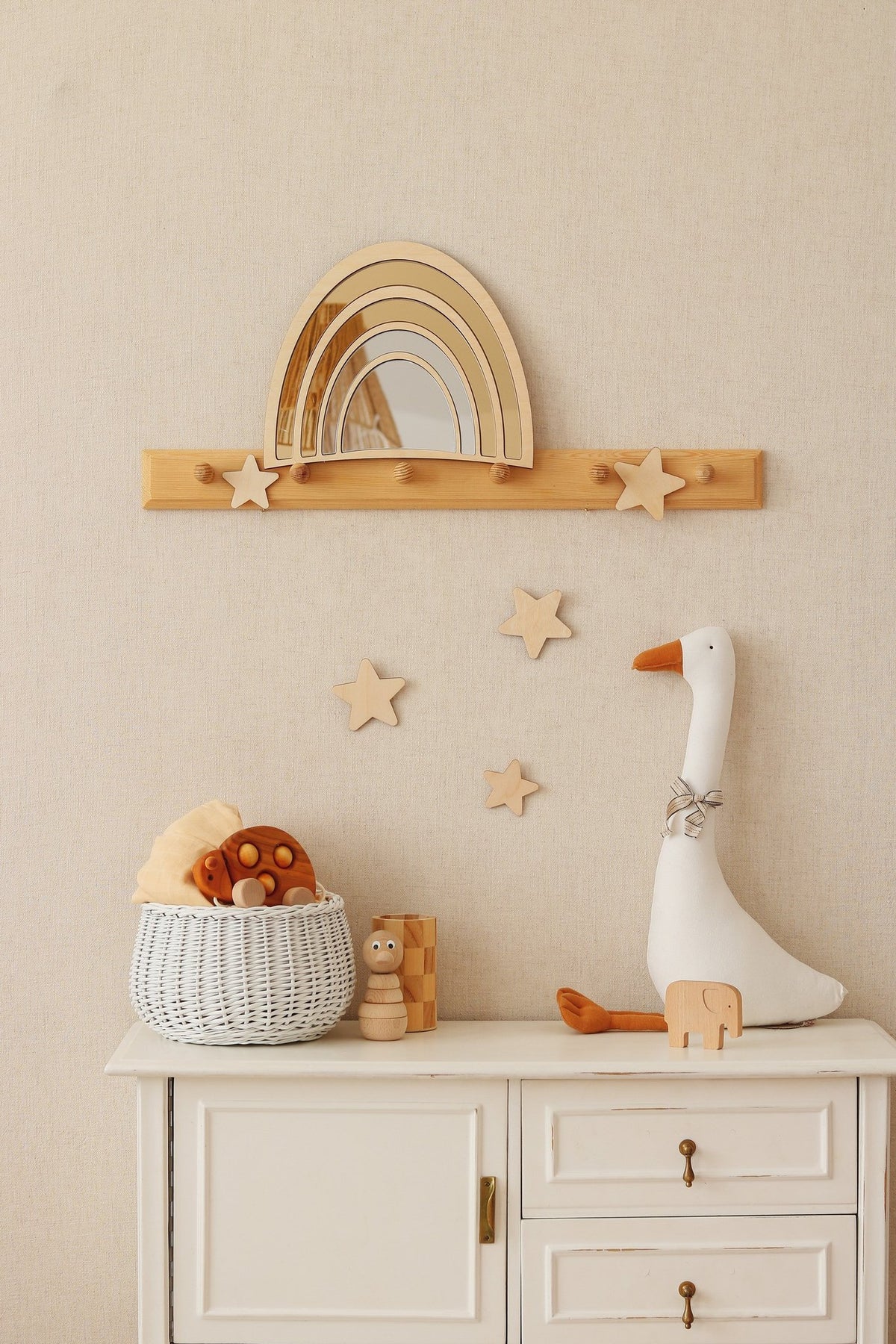 2. Rainbow mirror with gold-tinted acrylic and plywood frame on wall above nursery shelf with toys and star decorations