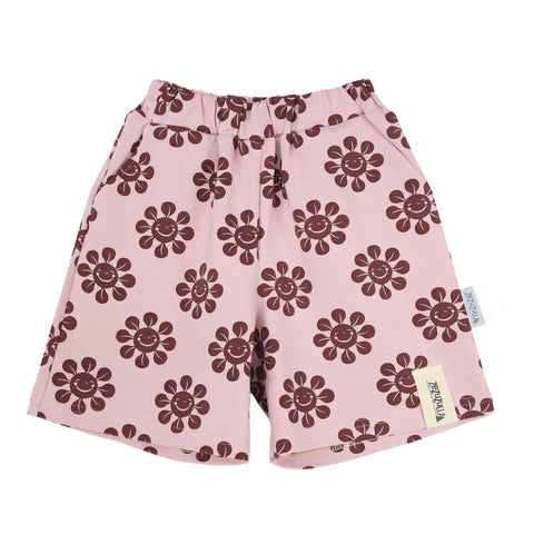 2. Kids' pink shorts with brown smiley flower print, featuring stretchy waistband and pockets, made from soft OEKO-TEX cotton and elastane blend, shown in studio setting