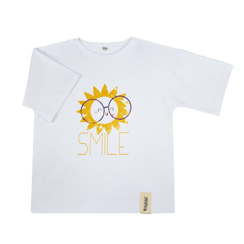 4. Flat lay of white Zezuzulla T-shirt featuring cheerful sun with glasses and 'SMILE' text, made from soft cotton