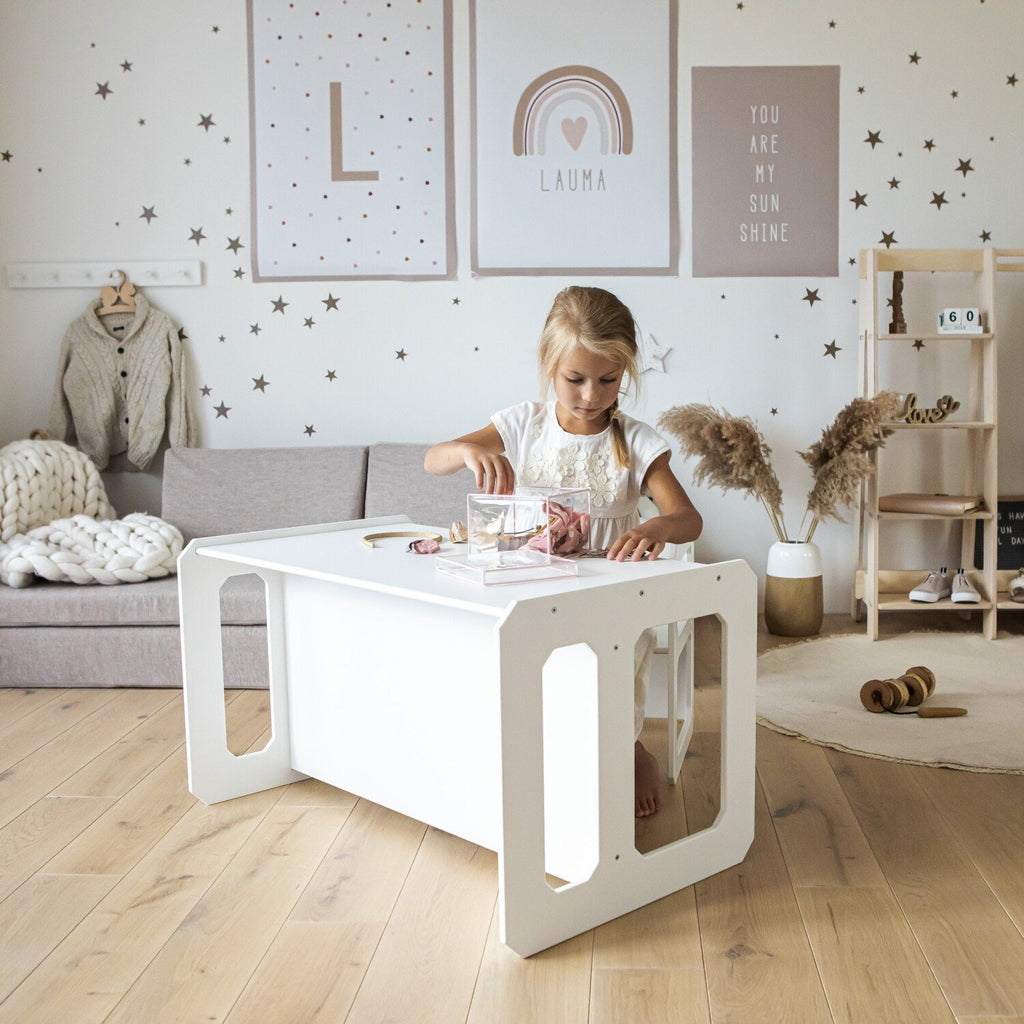 18. Girl playing at a white Montessori table in a stylish, decorated living room