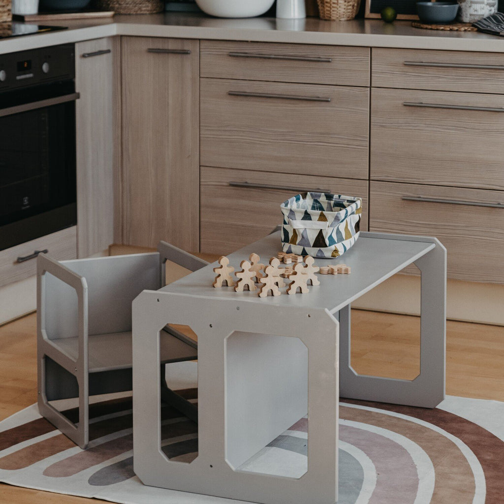 17. Grey Montessori table and chair set in a kitchen with a chess set on top