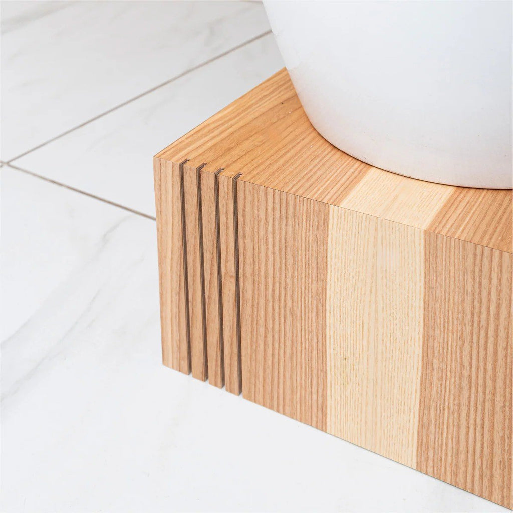 4. Close-up of wooden plant stand on white tile floor showing natural wood grain and texture