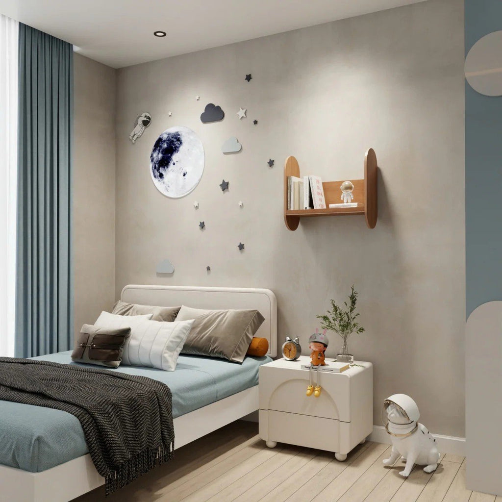 1. Kids' room with wall-mounted wooden bookshelf holding books and toy, next to bed with moon and star wall decor