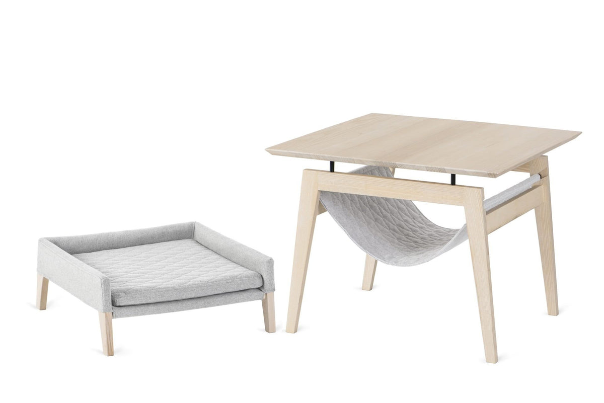 2. Studio shot of Labbvenn Kikko table and Lulu bed in ash wood with grey fabric, showcasing modern pet furniture design