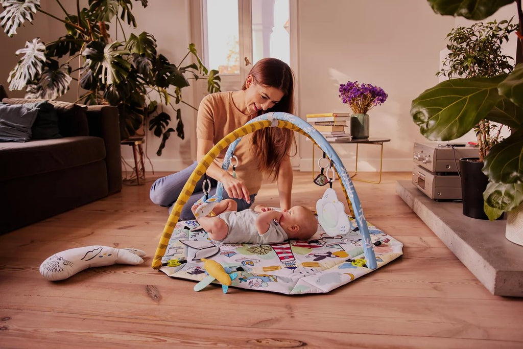 8. Woman engaging with baby on Kinderkraft Smartplay Sea playmat in bright living room