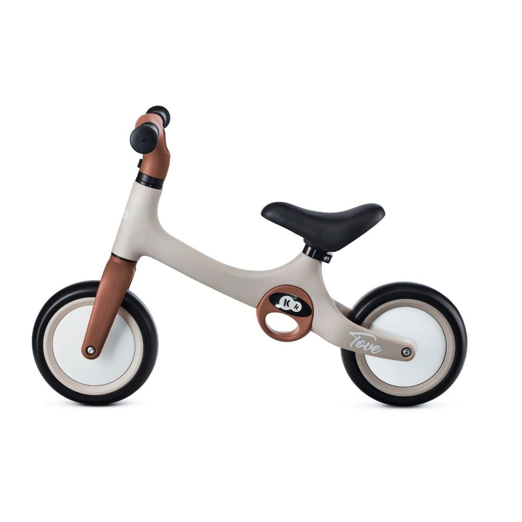 2. Side profile of beige Kinderkraft TOVE balance bike with black seat and foam wheels