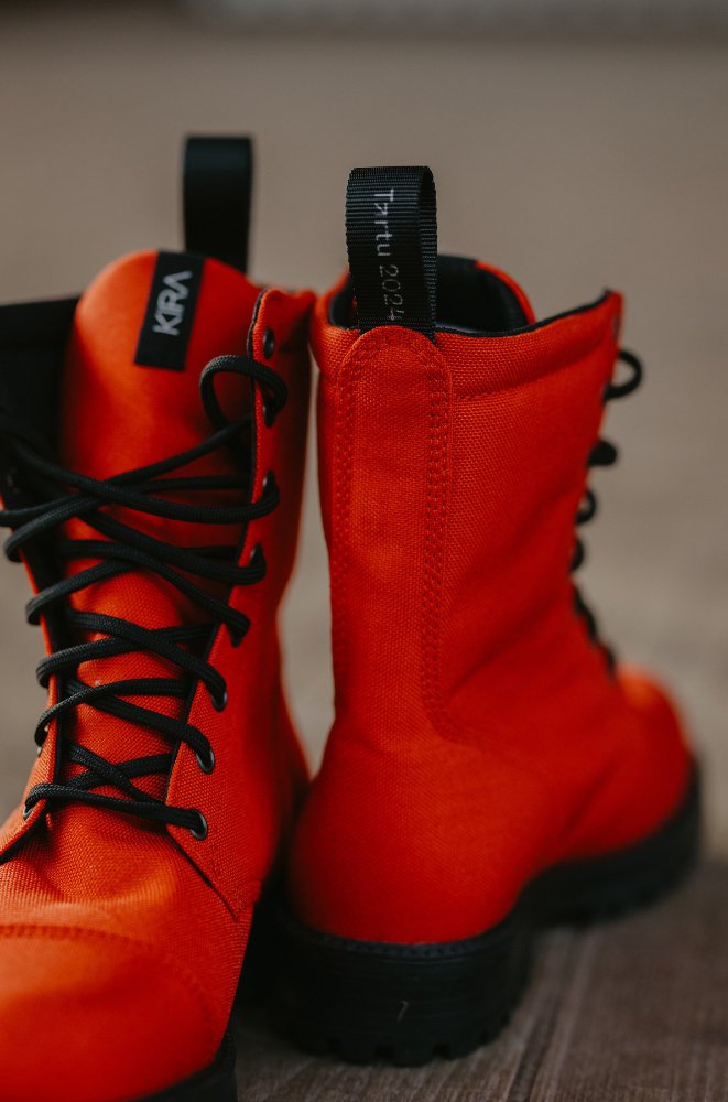 4. Detail of KIRA 5.0 red boots highlighting recycled textile upper and branding