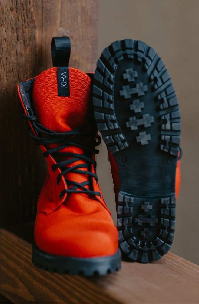 3. Close-up of KIRA 5.0 red boots showing sole tread pattern and vegan design