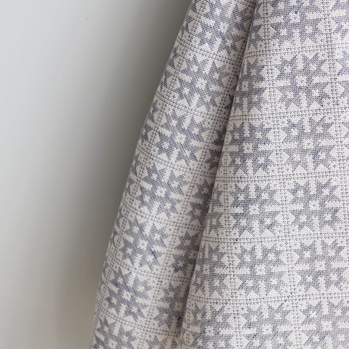 3. Close-up of Pärnumaa folk art pattern on kitchen towel, highlighting intricate grey and white design