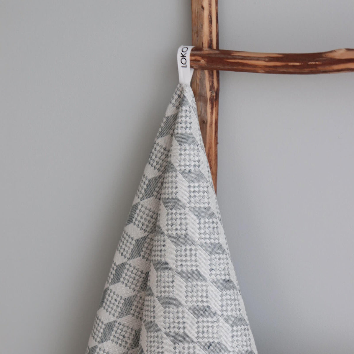 2. Close-up of kitchen towel with Virumaa folk art pattern, highlighting LOKO brand tag and texture