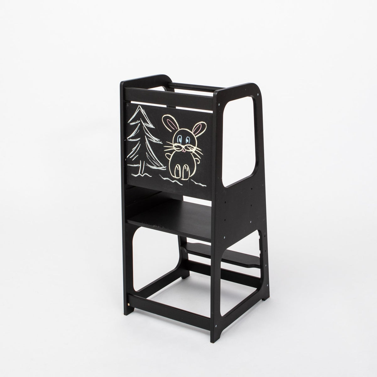 1. Black Montessori kitchen helper tower with blackboard panel featuring a drawing of a rabbit and tree, shown in a studio setting