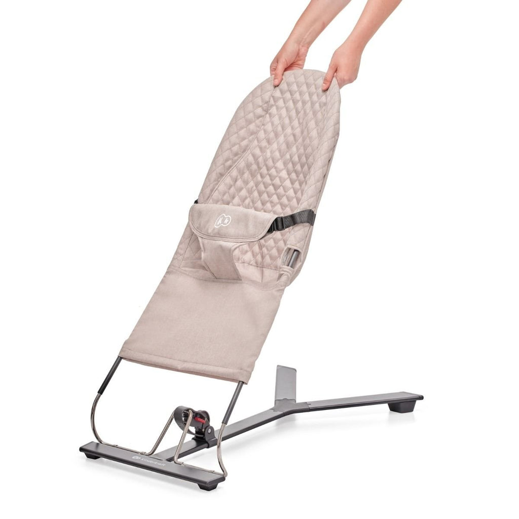 3. Close-up of beige Kinderkraft MIMI baby bouncer showing adjustable backrest being lifted by hands