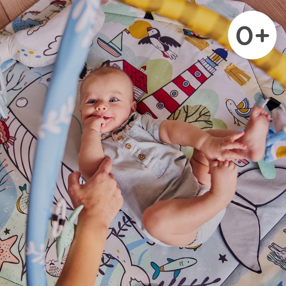 5. Baby playing on Kinderkraft Smartplay Sea playmat with colorful underwater print and plush toys