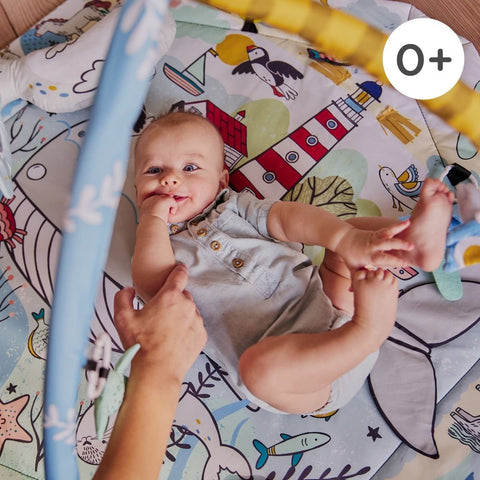 5. Baby playing on Kinderkraft Smartplay Sea playmat with colorful underwater print and plush toys