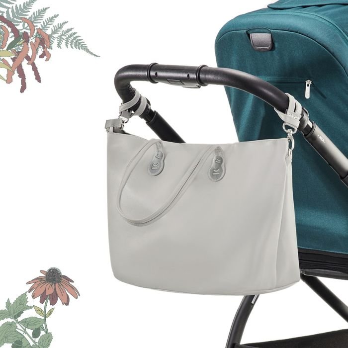 1. Light grey Kinderkraft Treasurebag attached to stroller handle with floral accents in background