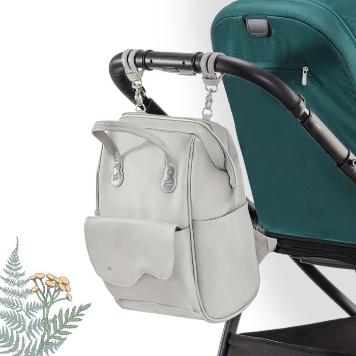 9. Grey Kinderkraft Treasureback backpack attached to stroller handle with floral background