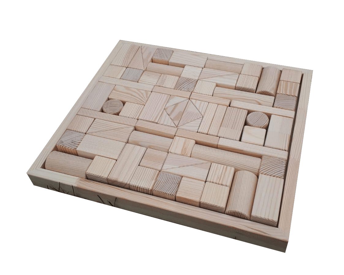 2. Flat lay of hand-made wooden blocks set neatly organized in a wooden tray, highlighting the variety of shapes and pinewood material