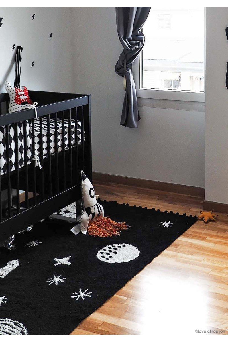 1. Knitted rocket pillow in natural and dark gray with colorful fringes in a nursery with black and white decor