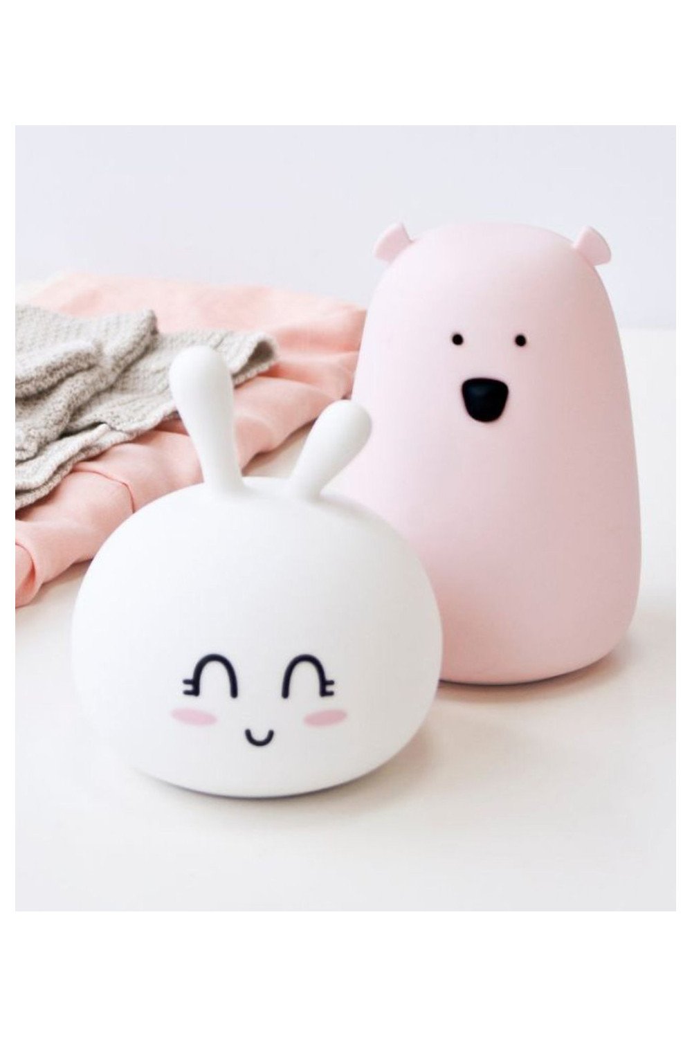 2. White Bunny Silicone Lamp and pink bear lamp on a white surface with soft fabric in the background