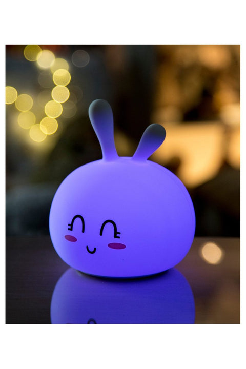 5. Glowing purple Bunny Silicone Lamp with smiling face in a softly lit room