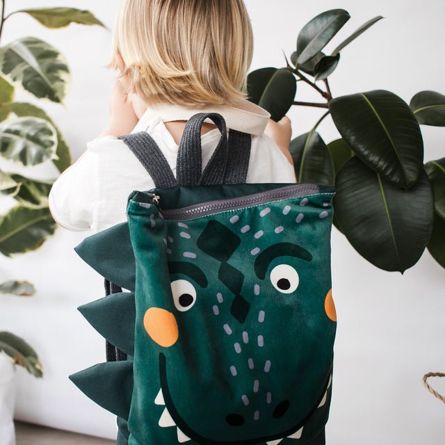 8. Close-up of Muni dinosaur backpack showing playful design