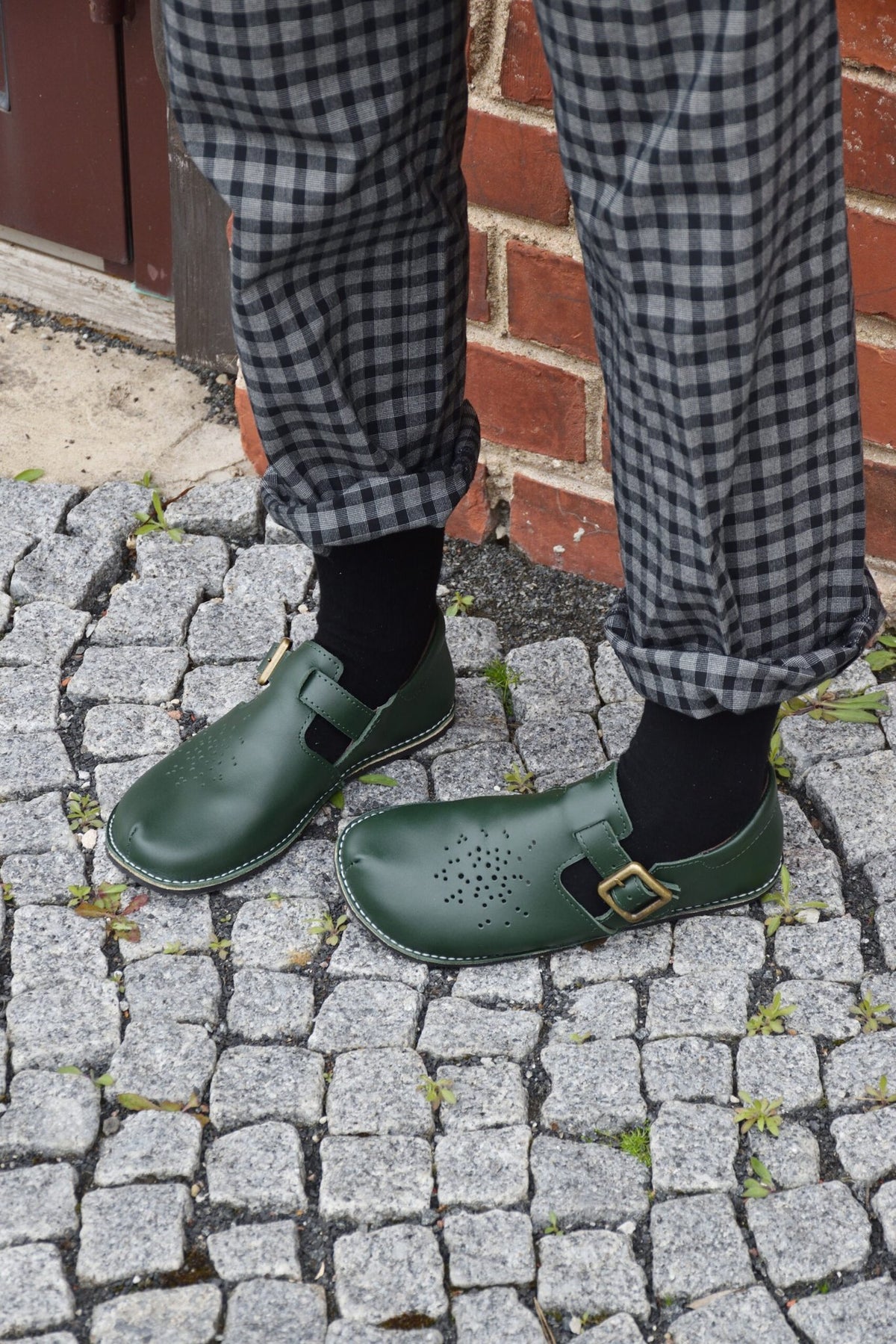 7. Studio shot of Kuuda Shoes in dark green, highlighting the wide toe area and perforated leather upper