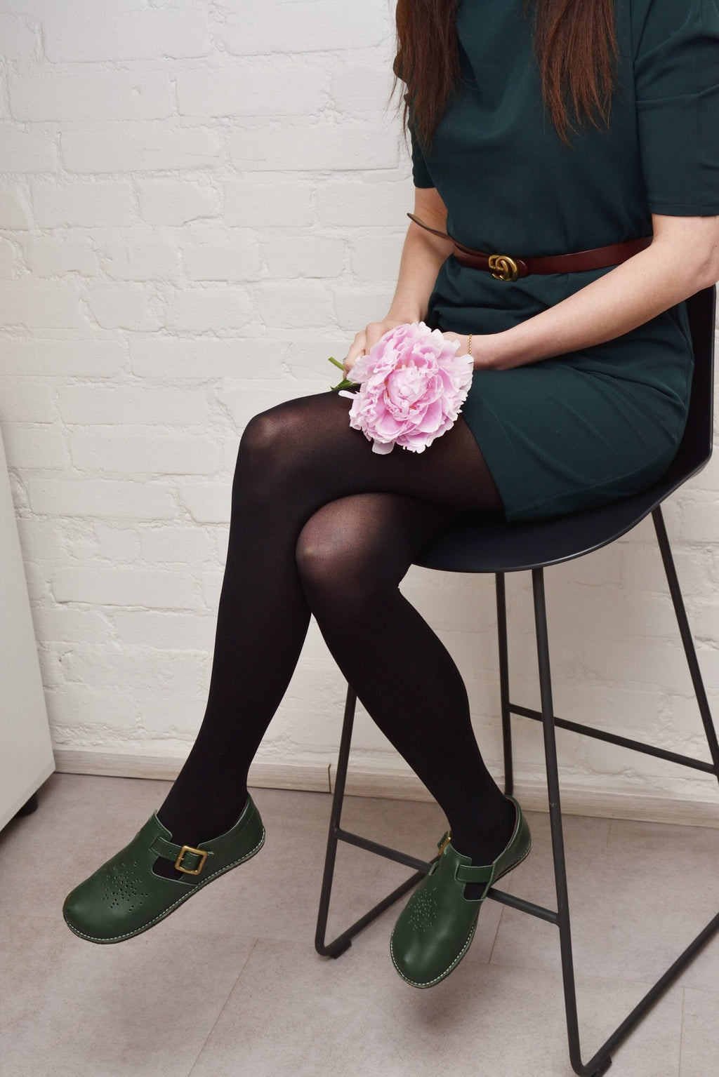 1. Men's Kuuda Shoes in dark green worn with checkered pants, showcasing casual style on cobblestone path