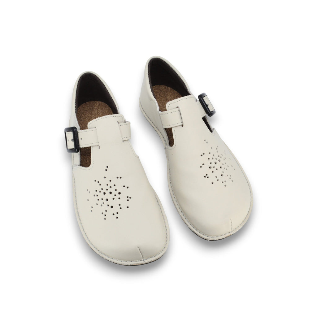 3. Studio shot of Omaking Kuuda Shoes in white, featuring perforated design and adjustable buckle straps